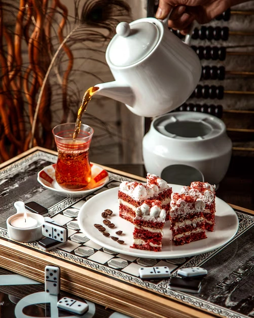 Red-velvet-cake-with-whipped-cream-served-with-tea-on-the-table